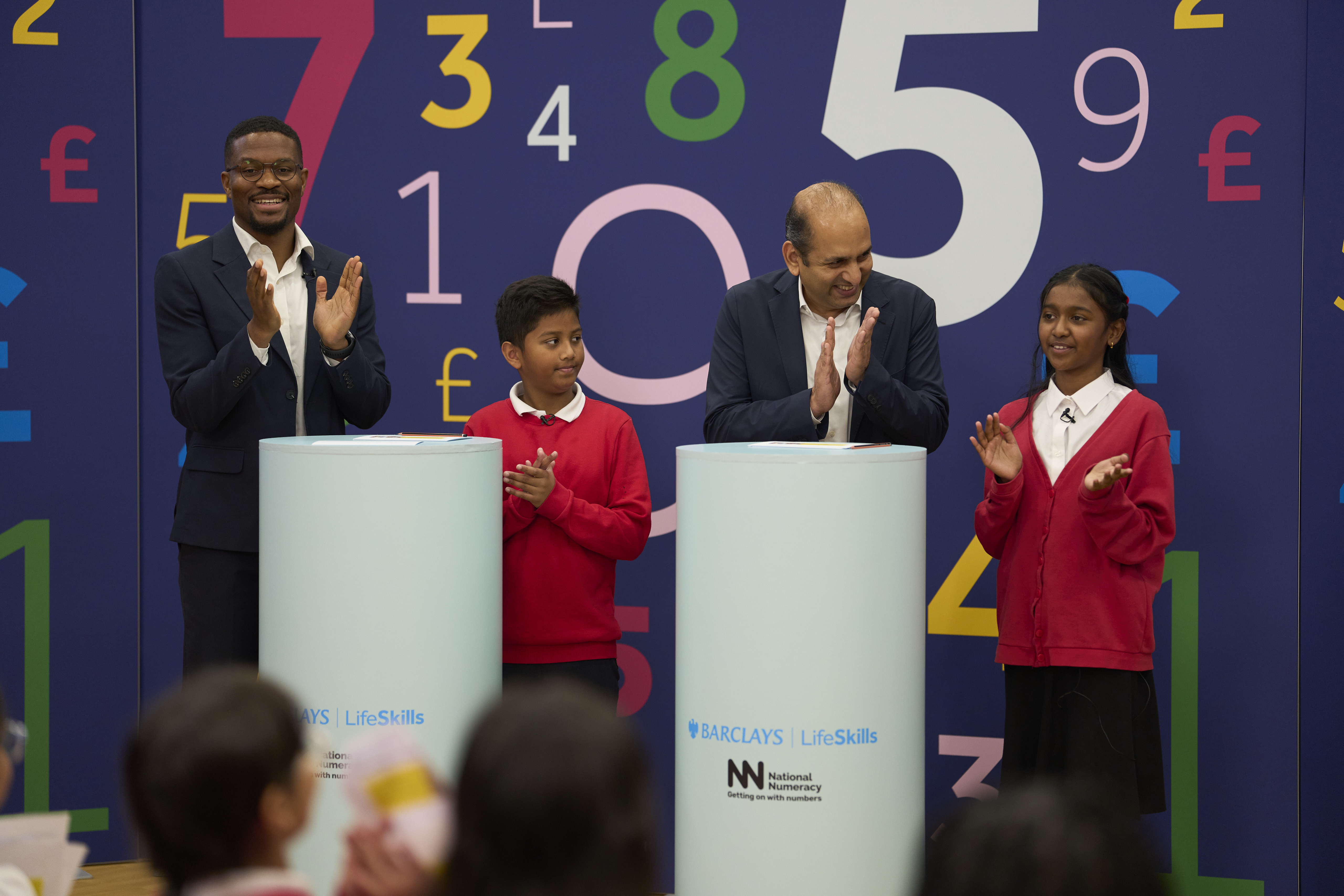 Rotimi Merriman-Johnson and Vim Maru take part in the Wheel of Numbers live assembly with school pupils