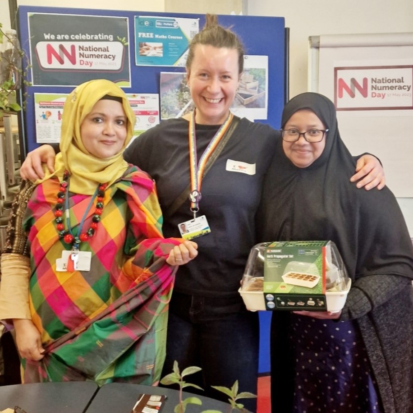 People at a National Numeracy event, learning to grow their own vegetables