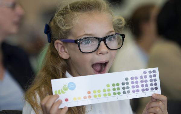 Photo of a young girl holding a National Numeracy number line