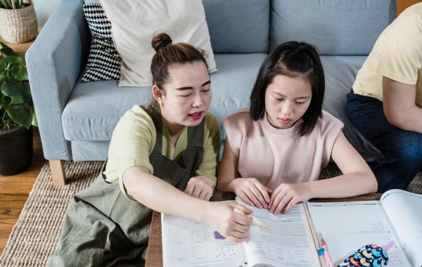 Mother helping daughter with homework