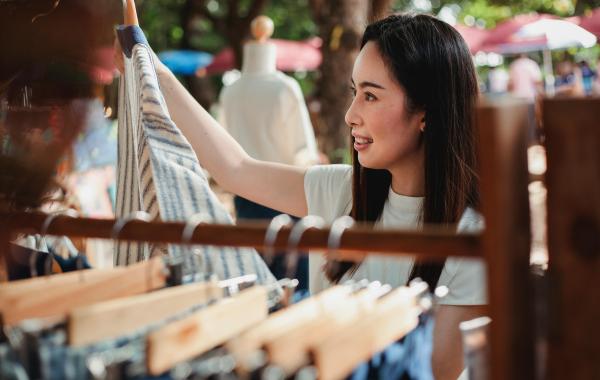 Person looking at clothes from a rack