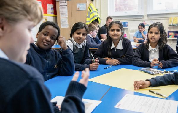 School pupils listening to a corporate volunteer