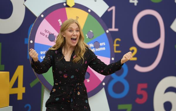 TV presenter Maddie Moate hosting the Wheel of Numbers live assembly