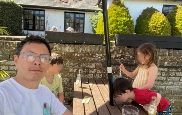 Maurice with his children at a pub table