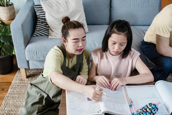 Mother helping daughter with homework