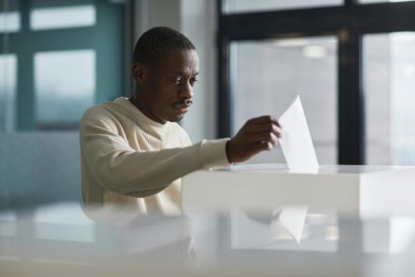 Man voting at ballot box