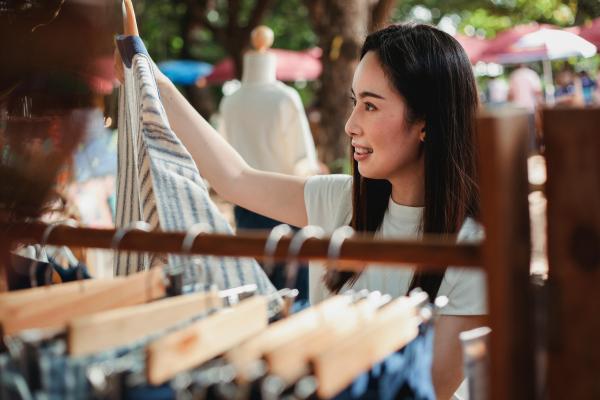 Person looking at clothes from a rack
