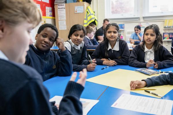 School pupils listening to a corporate volunteer