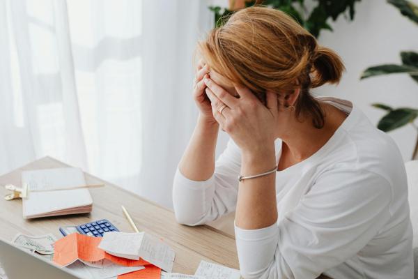 Person looking stressed with bills