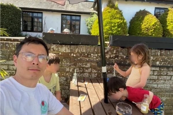 Maurice with his children at a pub table